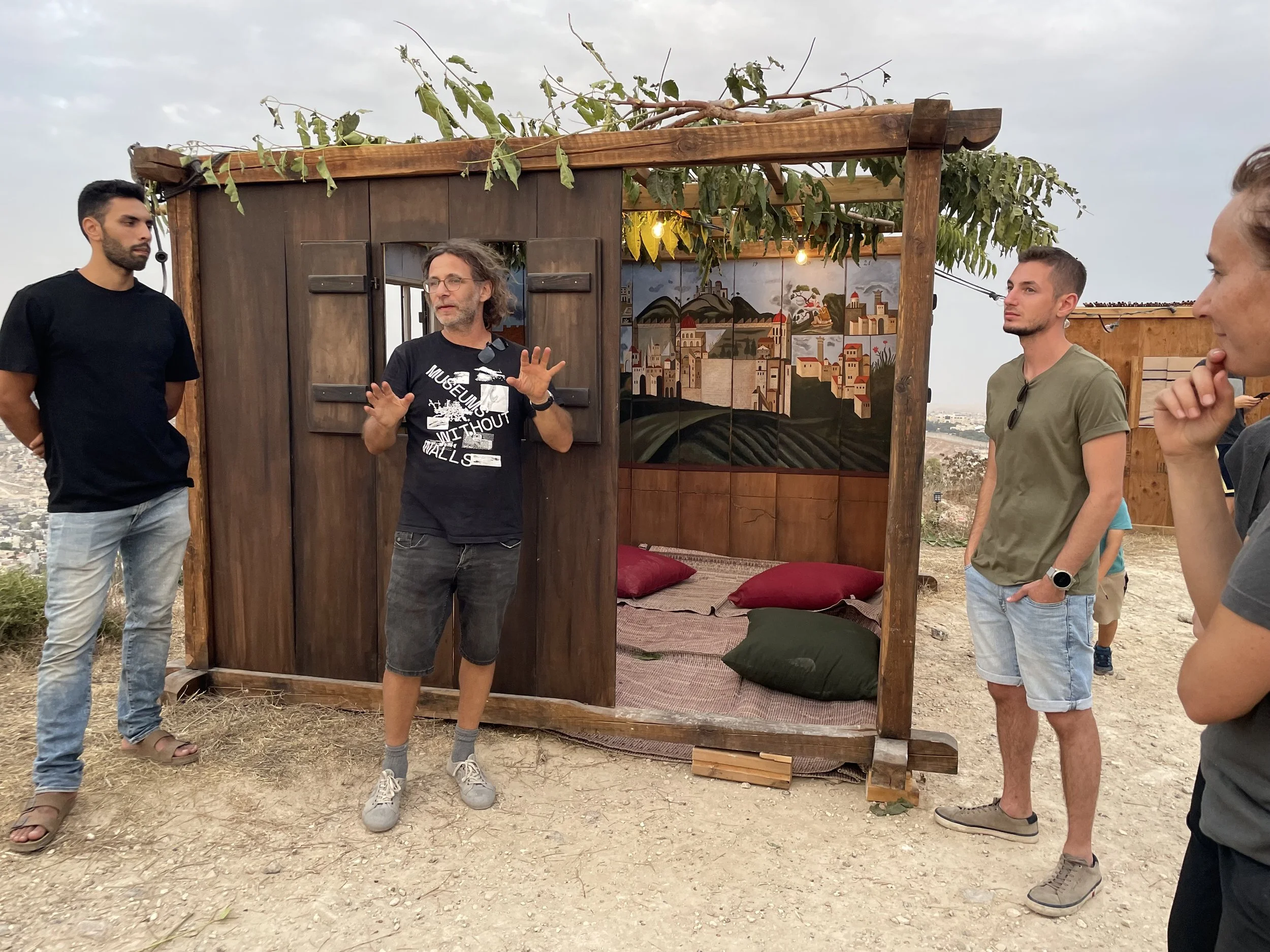 Diego-speaking-sukkah-outside.jpeg