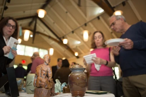 Guests mark their favorites from the table of glass and ceramic artworks.Thank you to 3-D artists Leigh Williams, Ann Welch, Paola Bari, Carolyn Edlund, Jeep Johnson, and Larissa Alvarado for their donations and support. 
