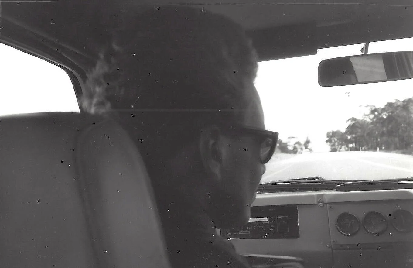 The author in the passenger seat - cheap sunglasses and no windscreen at 110kph on the Princes Hwy