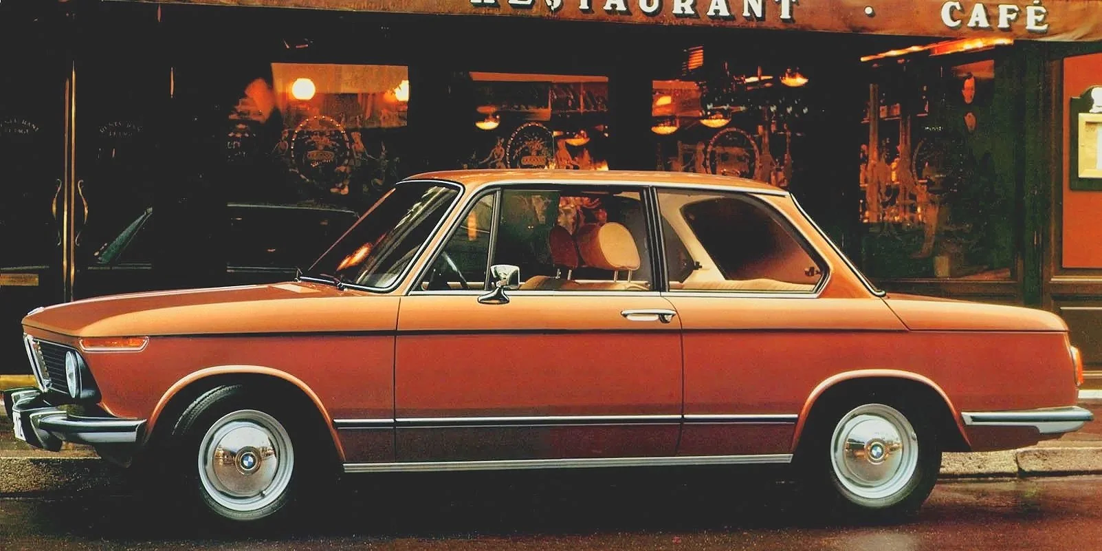 Vintage BMW advertisement gallery featuring classic 2002 and E30 3-Series 'Ultimate Driving Machine' print media.