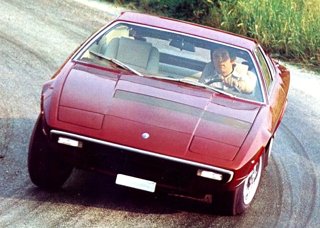 Original promotional image of a maroon 1974 Maserati Khamsin. Click to view the Maserati factory brochure and press photo collection.