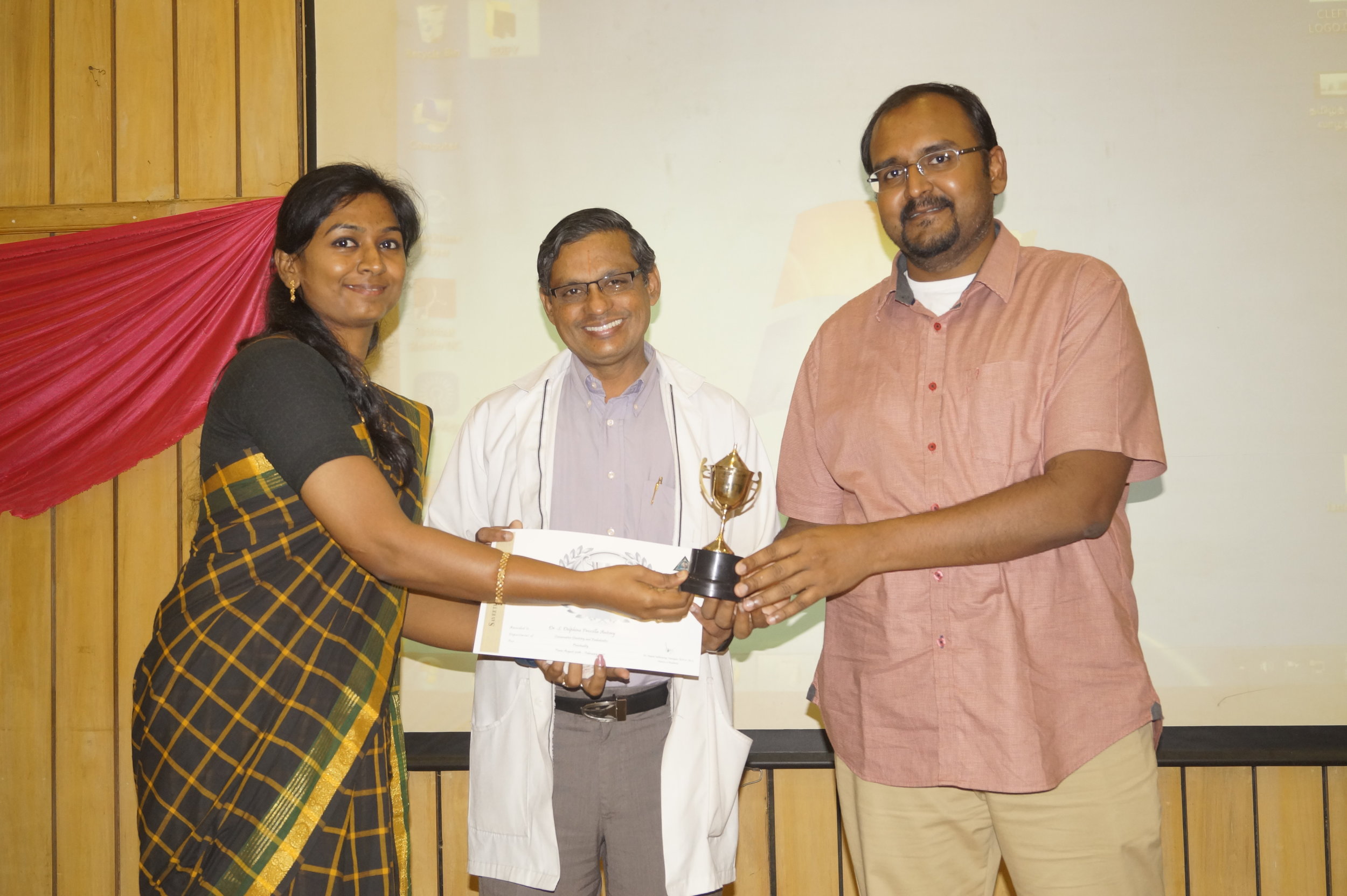 Dr. Delphine receiving Punctuality Award