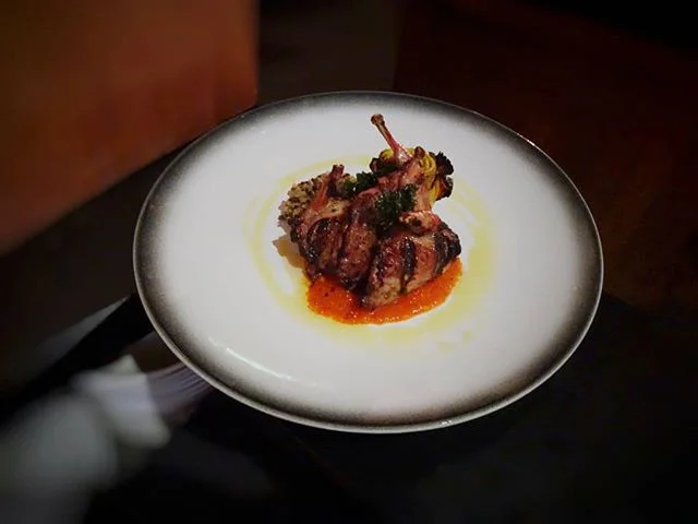 This entree is as scrumptious as it looks 😋| grilled quail, warm grain salad, grilled artichoke, vine tomato, apple cider &amp; garlic sauce 
#glutenfree