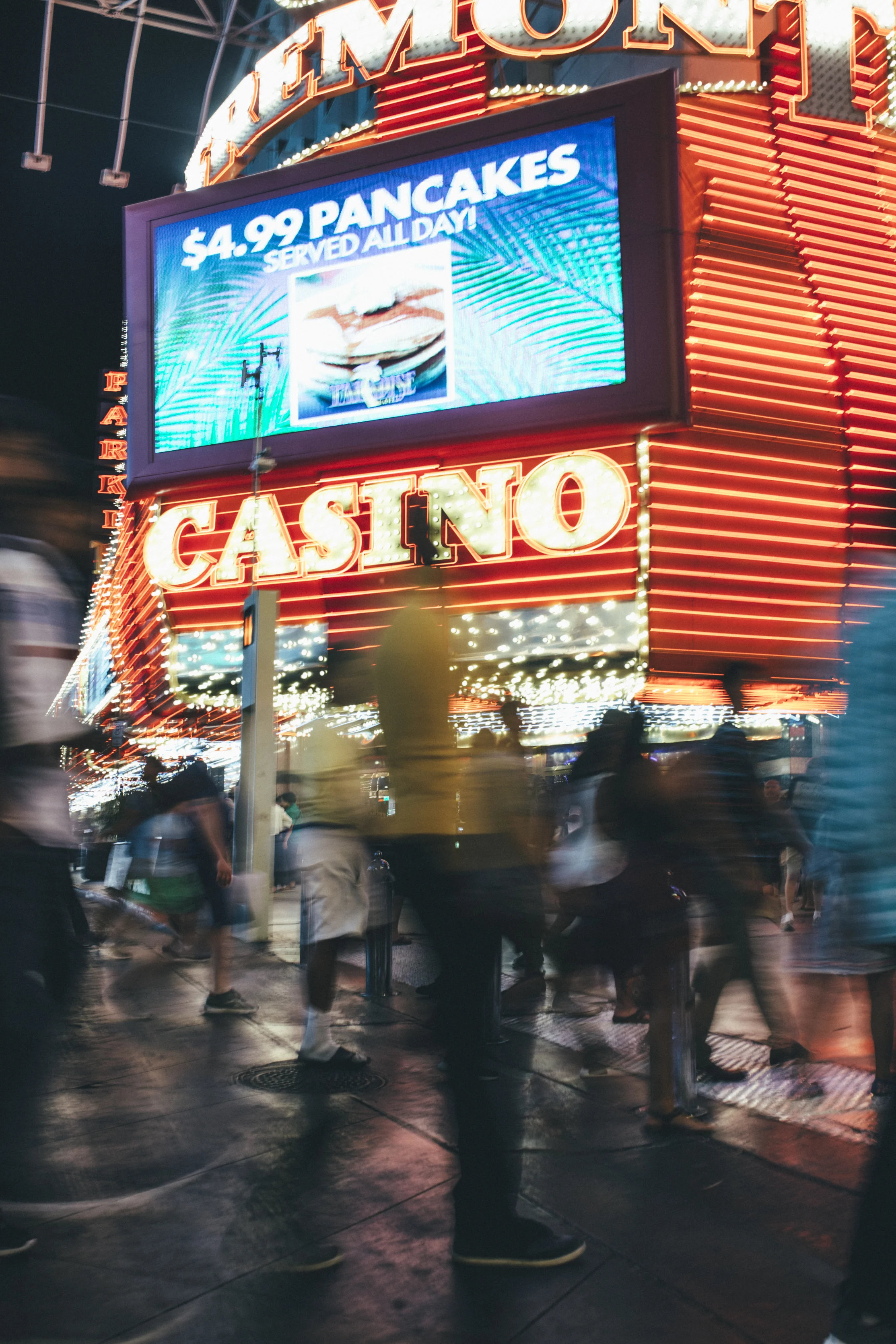 A photo by Luther Redd of the bustling Fremont Street at night.