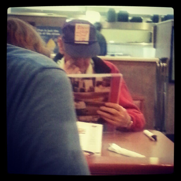 Sometimes you have to go to Denny's on a roundtrip. And sometimes you see this guy who has an index card in his old man hat with a hand written &quot;Obama + crap
=she
It!&quot;