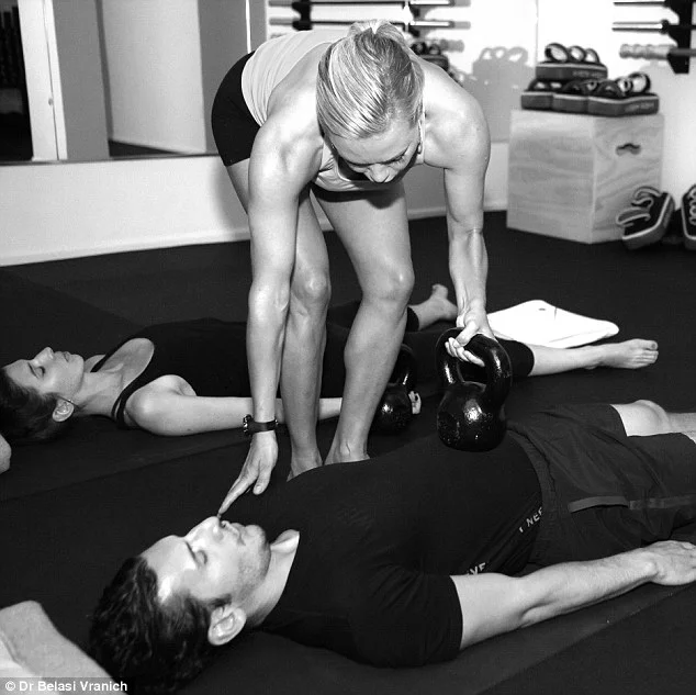 When we breath properly, Dr Belisa says (center), our shoulders should not rise and fall, as she demonstrates to a client. She is one of a growing number of trainers that see diaphragm breathing as the key to building strength and avoiding injury