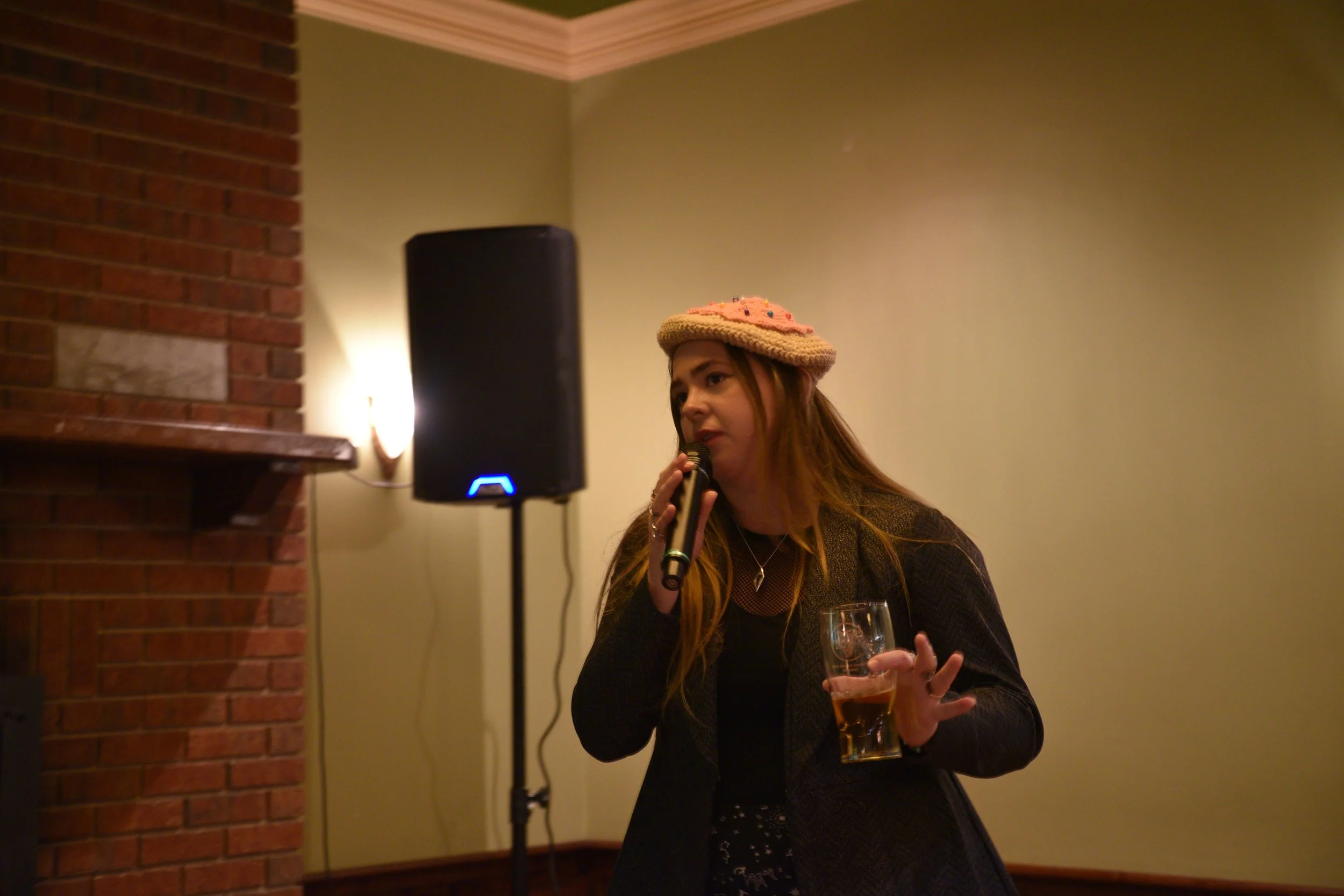  Jean E. Mueller-Burr MCs at Ghostlight Ensemble’s  fifth Holiday Cabernet , held on Dec. 17, 2023, at Mrs. Murphy &amp; Sons Irish Bistro.  (Photos by Maria Burnham)  