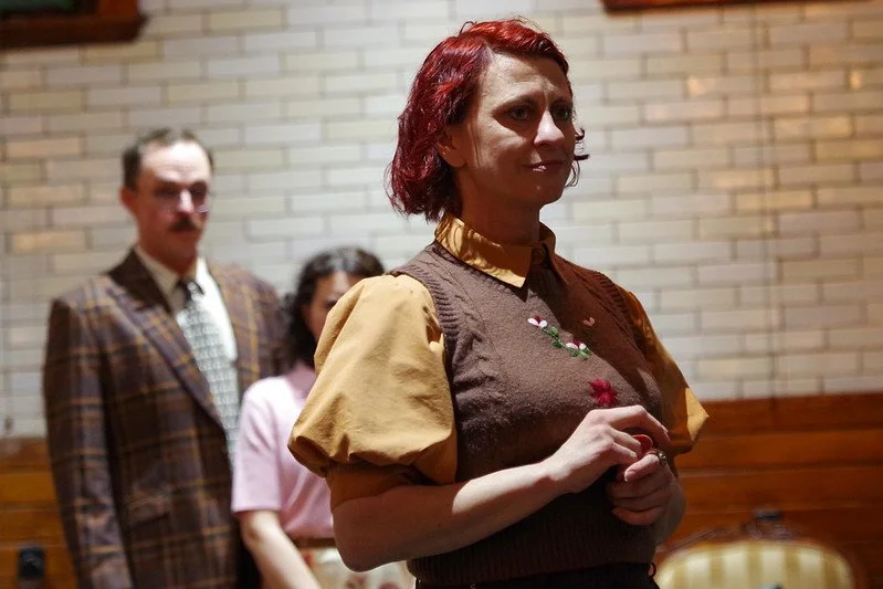  Maria Burnham as Latimer in Ghostlight Ensemble’s production of   The Dover Road   at the Glessner House in 2026.  (Photo by Pete Guither)  
