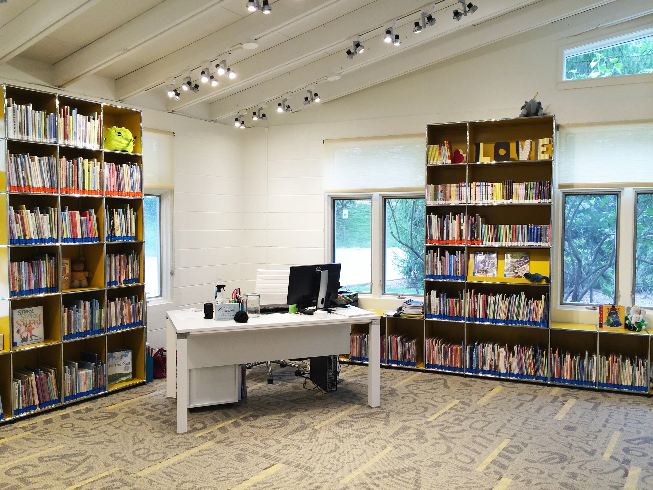 Custom shelving from USM, warm lighting from WAC, and Danish furniture from Jesper Office make the library a favorite spot for students and teachers, alike.