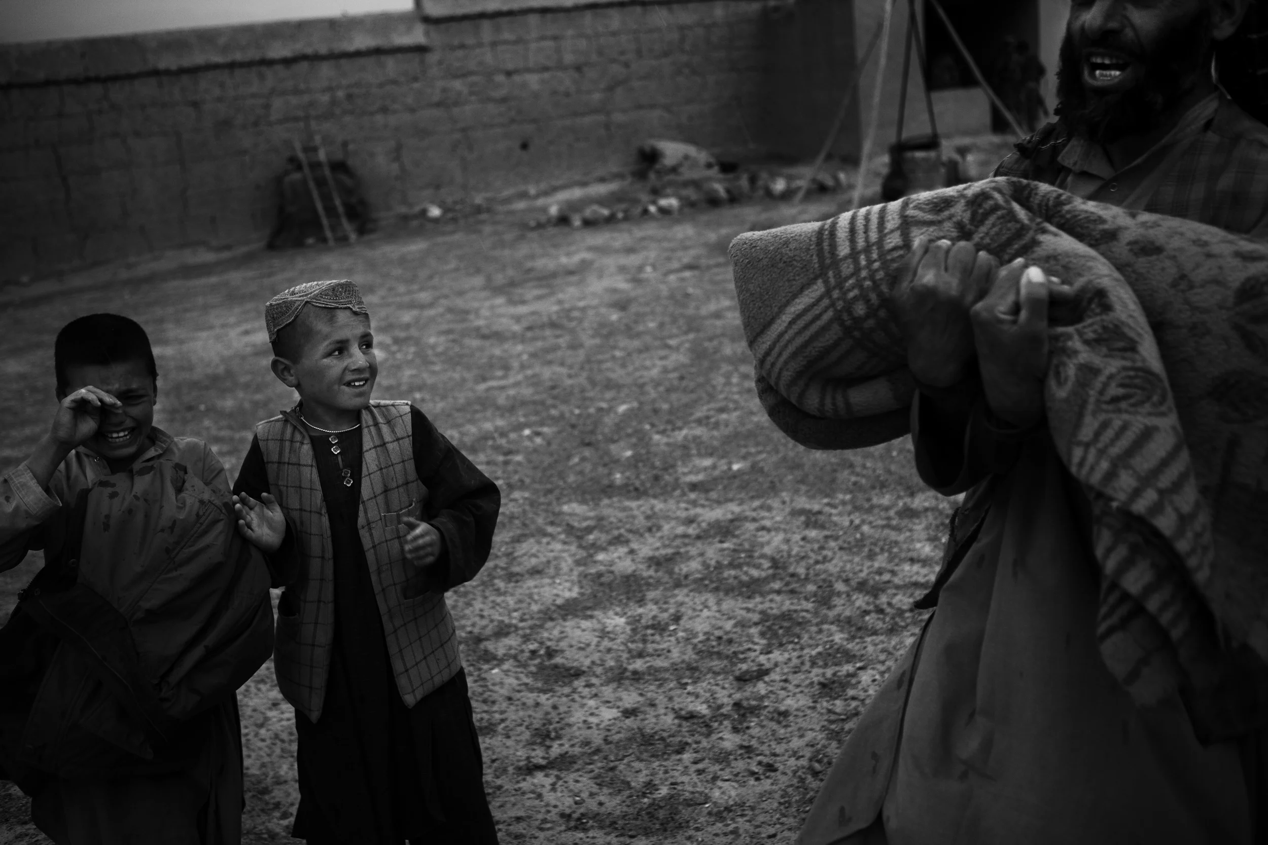  A pair of brothers cry as US soldiers take their father away for interrogation. 
