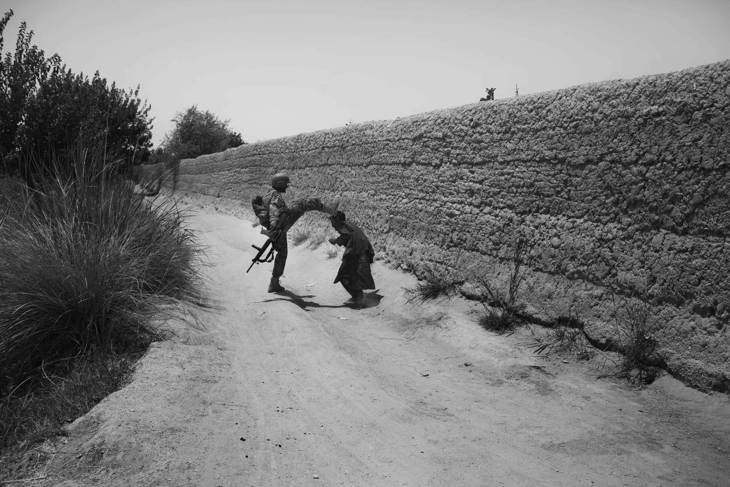  An Afghan Army soldier attacks a civilian after a firefight, Marjah. 