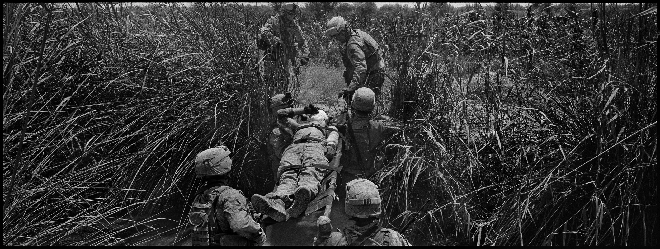  Cpl. Jimenez is carried across the canal. He lost his left arm in the blast. 