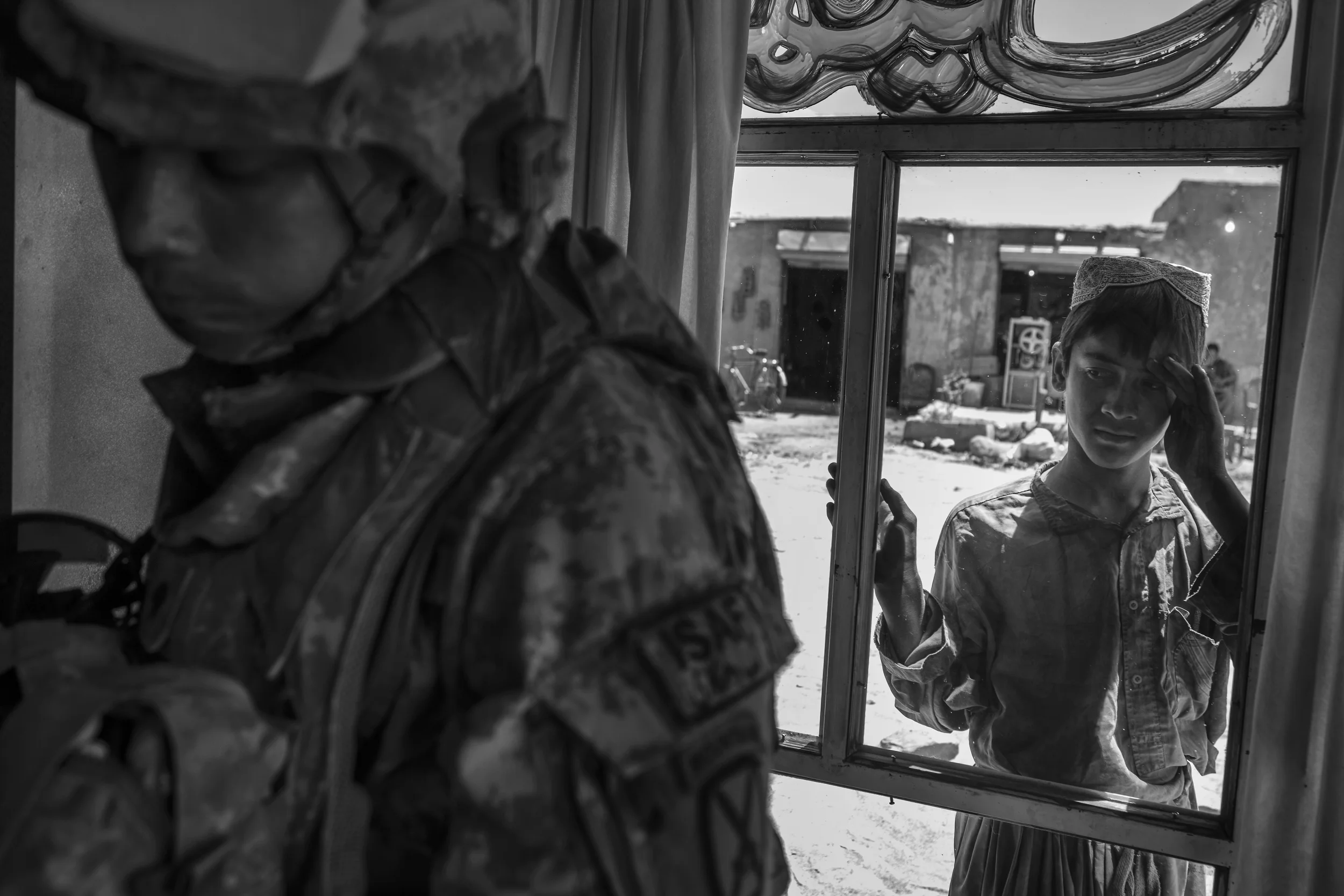  A boy watches Spc. Don Ezra Plemmons buy supplies, Sayedabad. 