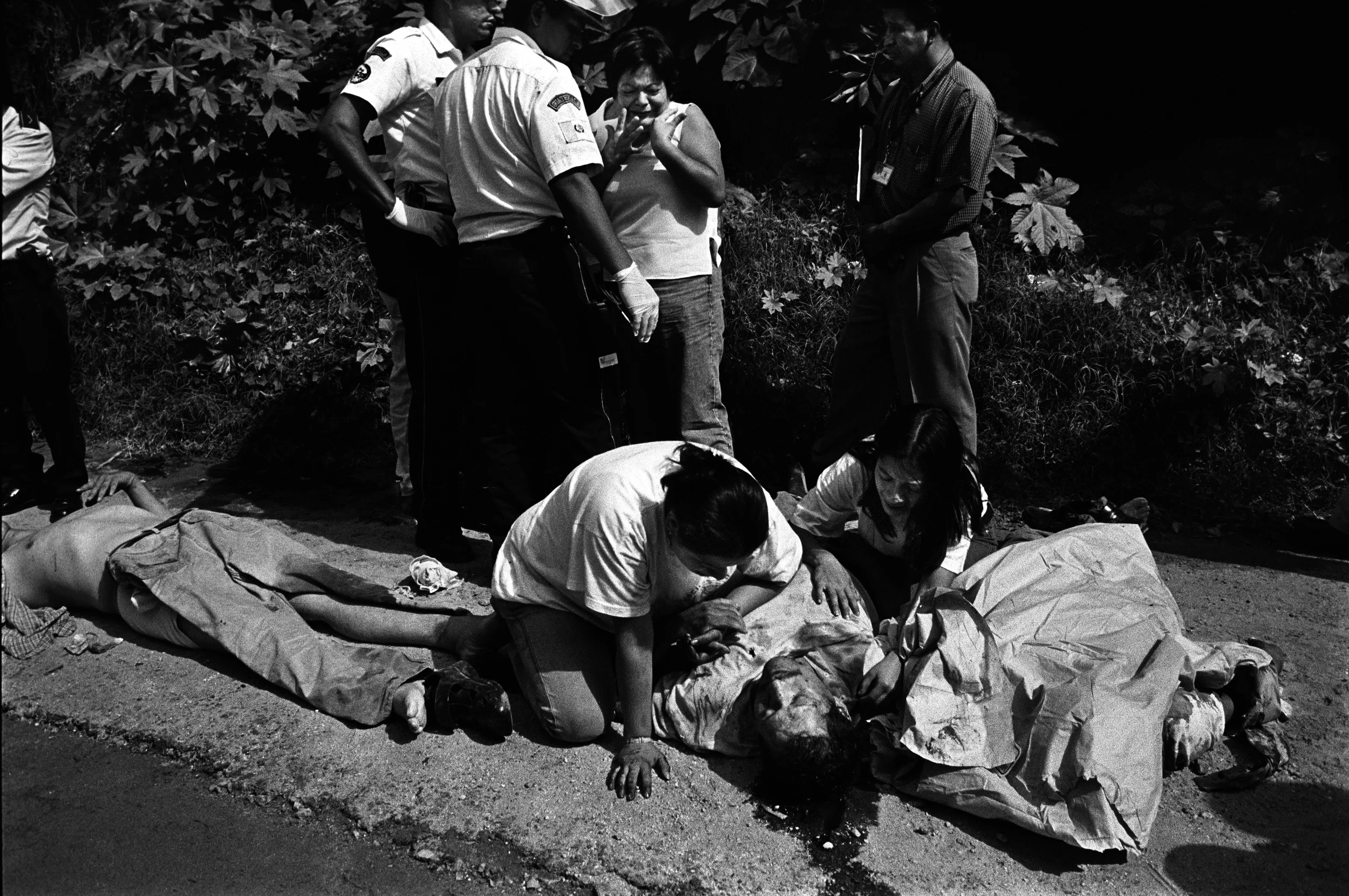  Women cry over the body of their slain father. 