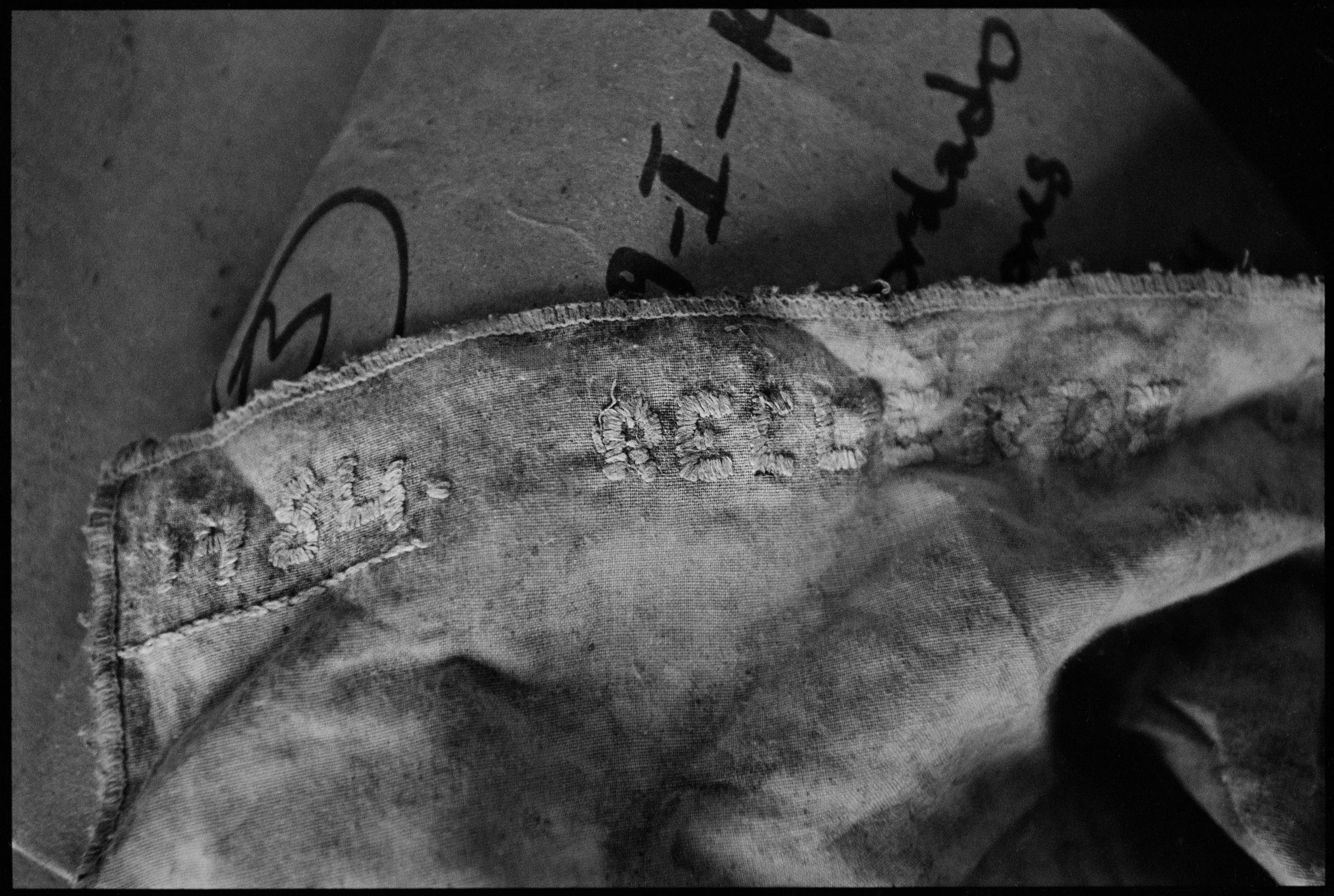  A hand embroidered kerchief, found with the victim of a massacre, that reads "1984• Remember."&nbsp; 