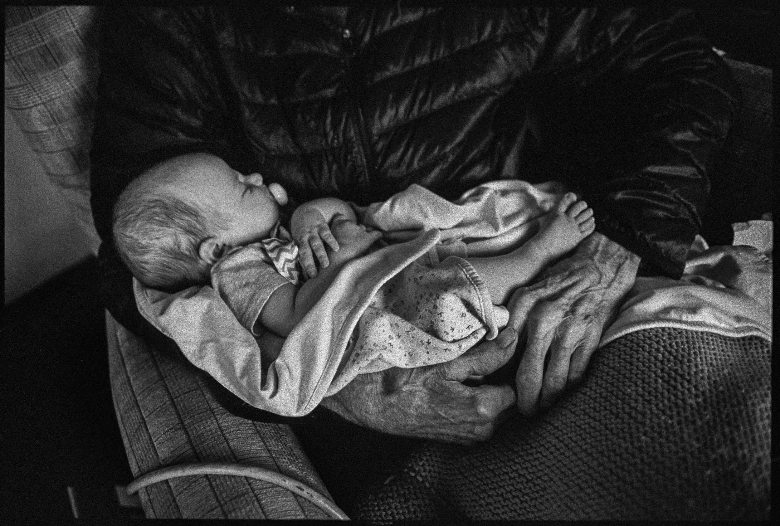  Holding his great-grandaughter Roslyn, one month old, days before he died. 