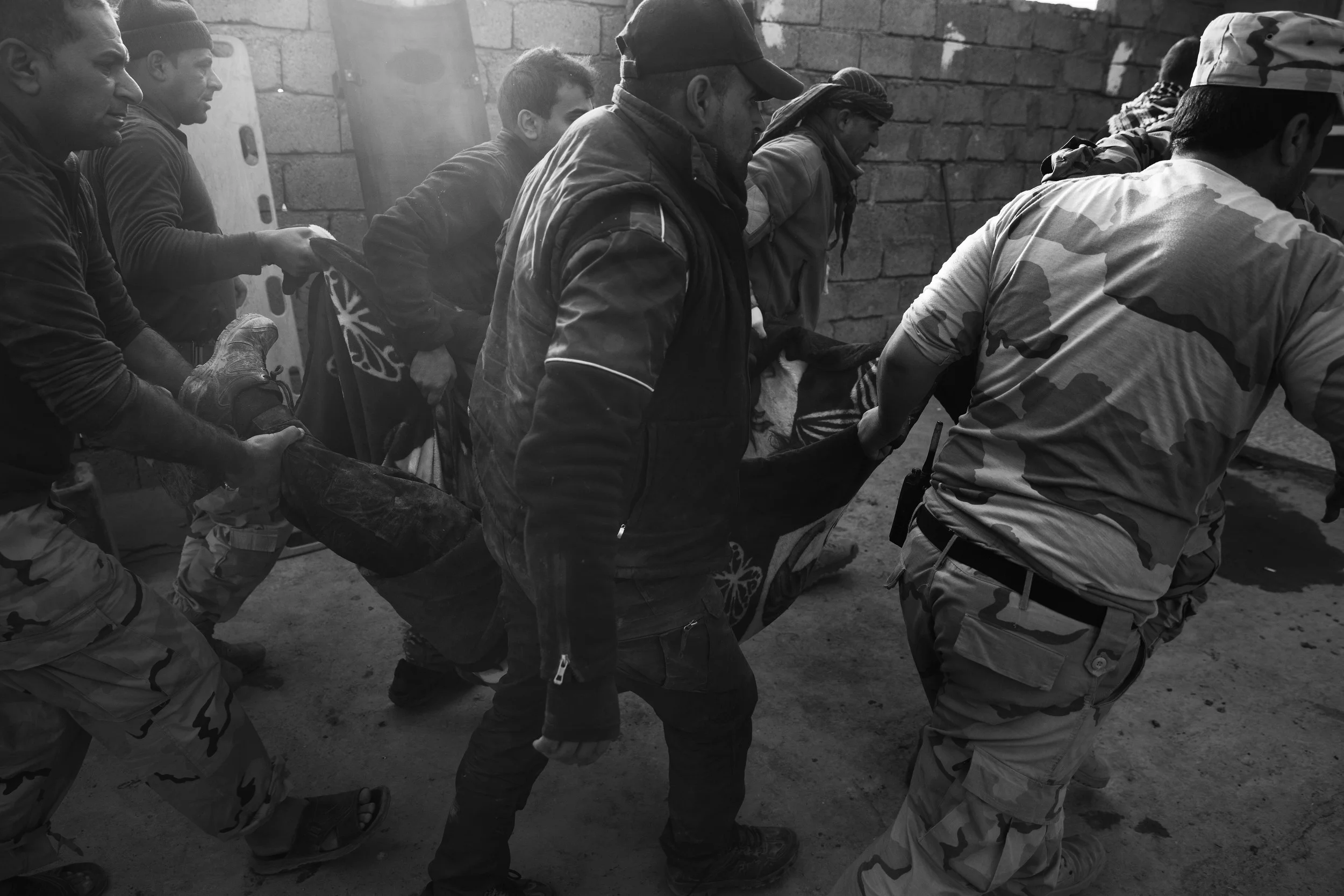  Wounded SWAT arrive for treatment at an Iraqi army aid station in the village of Sherazad. 
