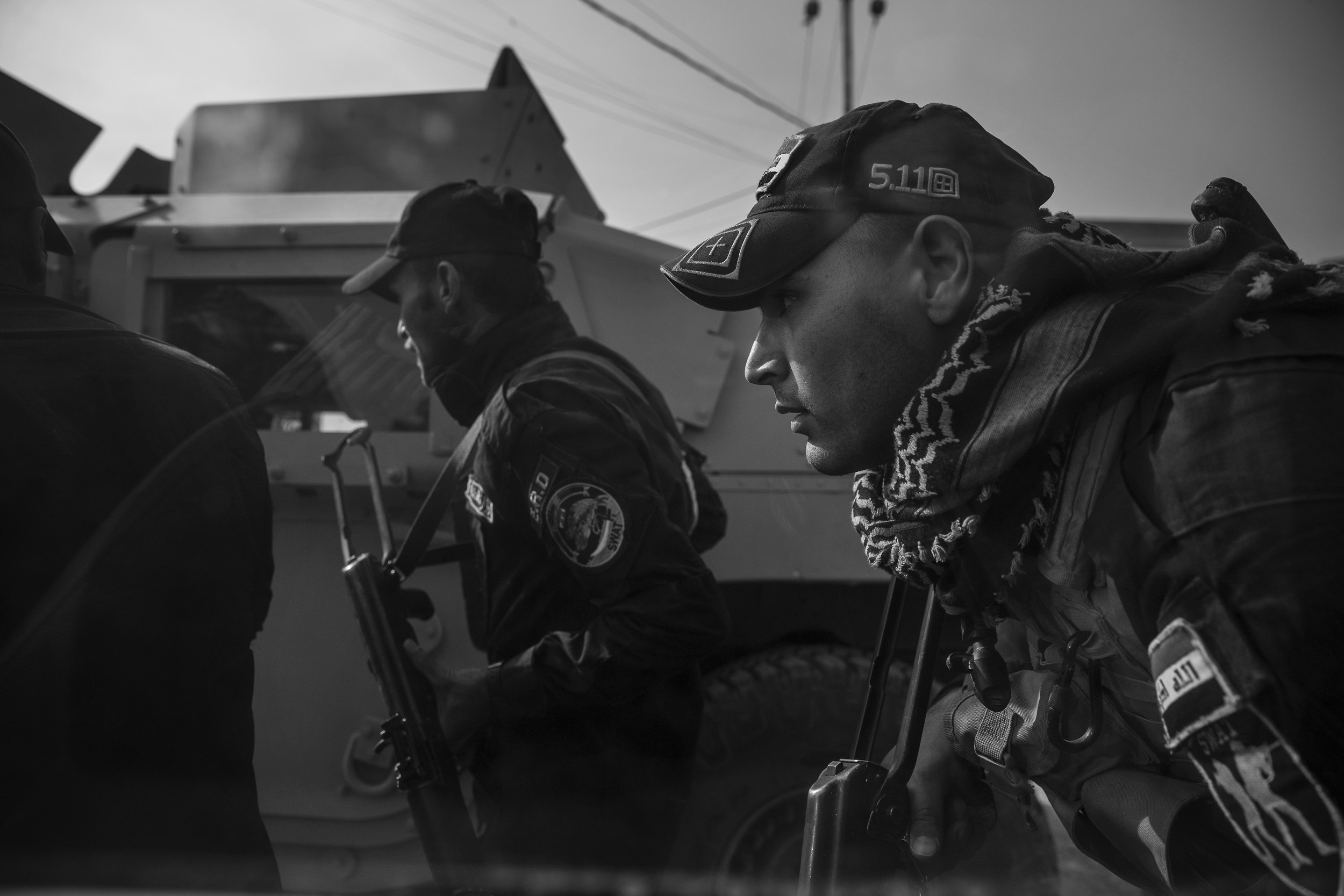  Safwan ducks behind a humvee to avoid sniper fire.&nbsp; 