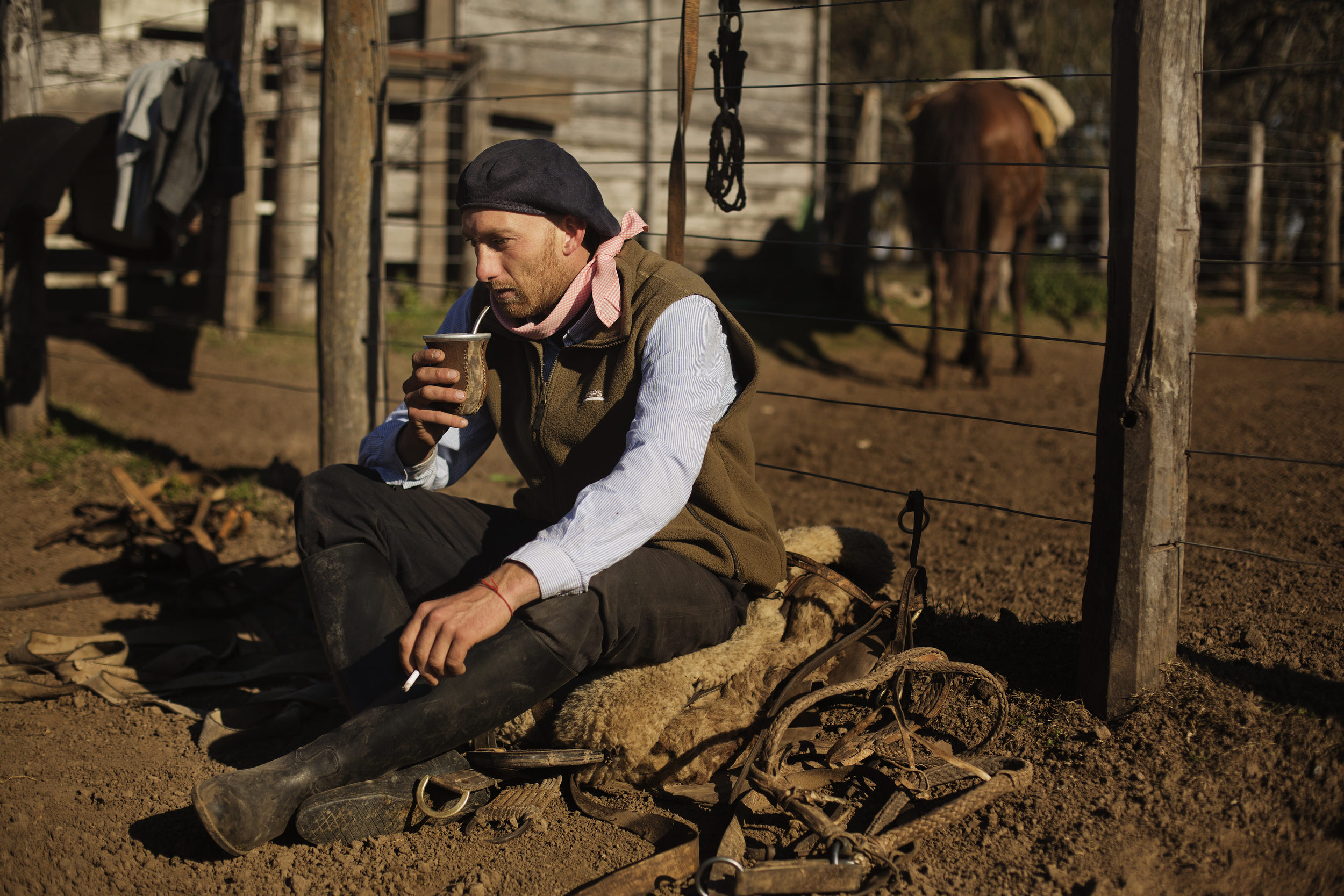  Luis takes a break from breaking horses to drink some maté. 