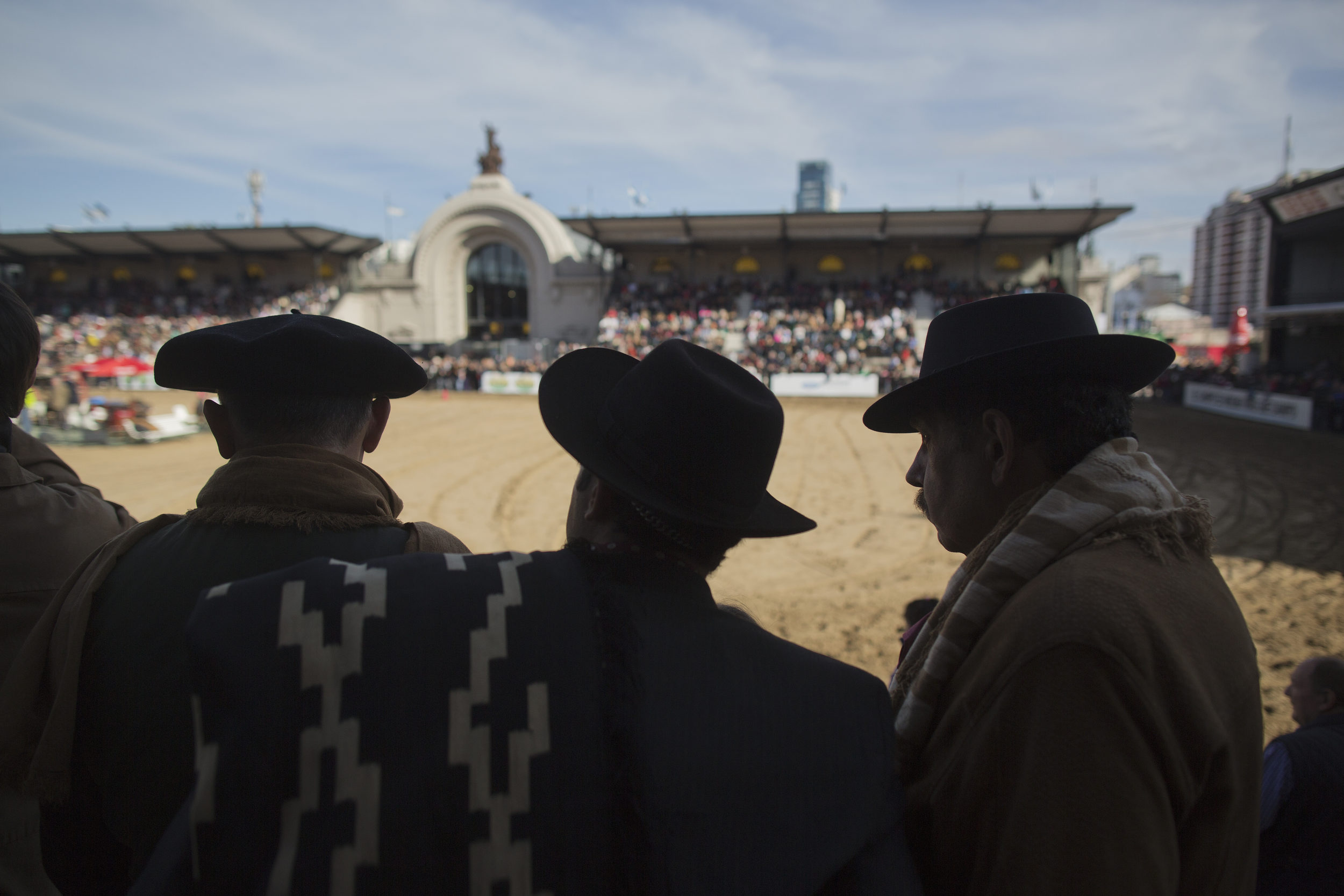  Gauchos watch horse competitions at the Rural Exposition in Buenos Aires. 