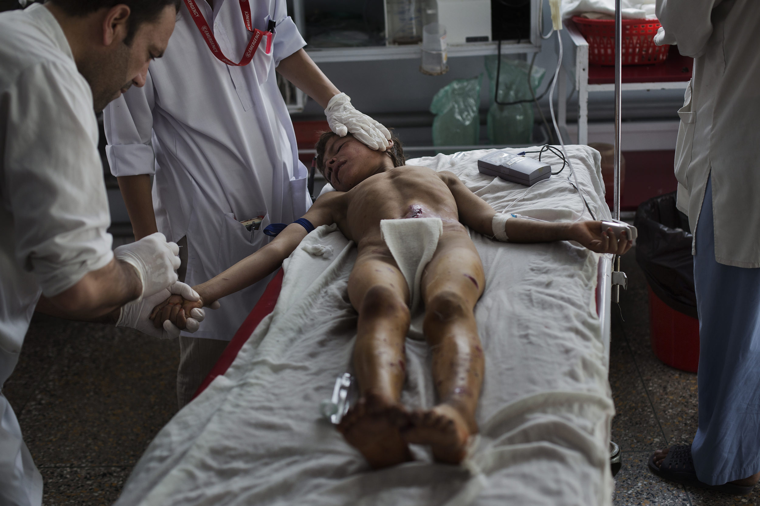  Salamy, 12, from Maidan Wardak, is treated by nurse Ahmad Shah for a shrapnel wound in his stomach 
