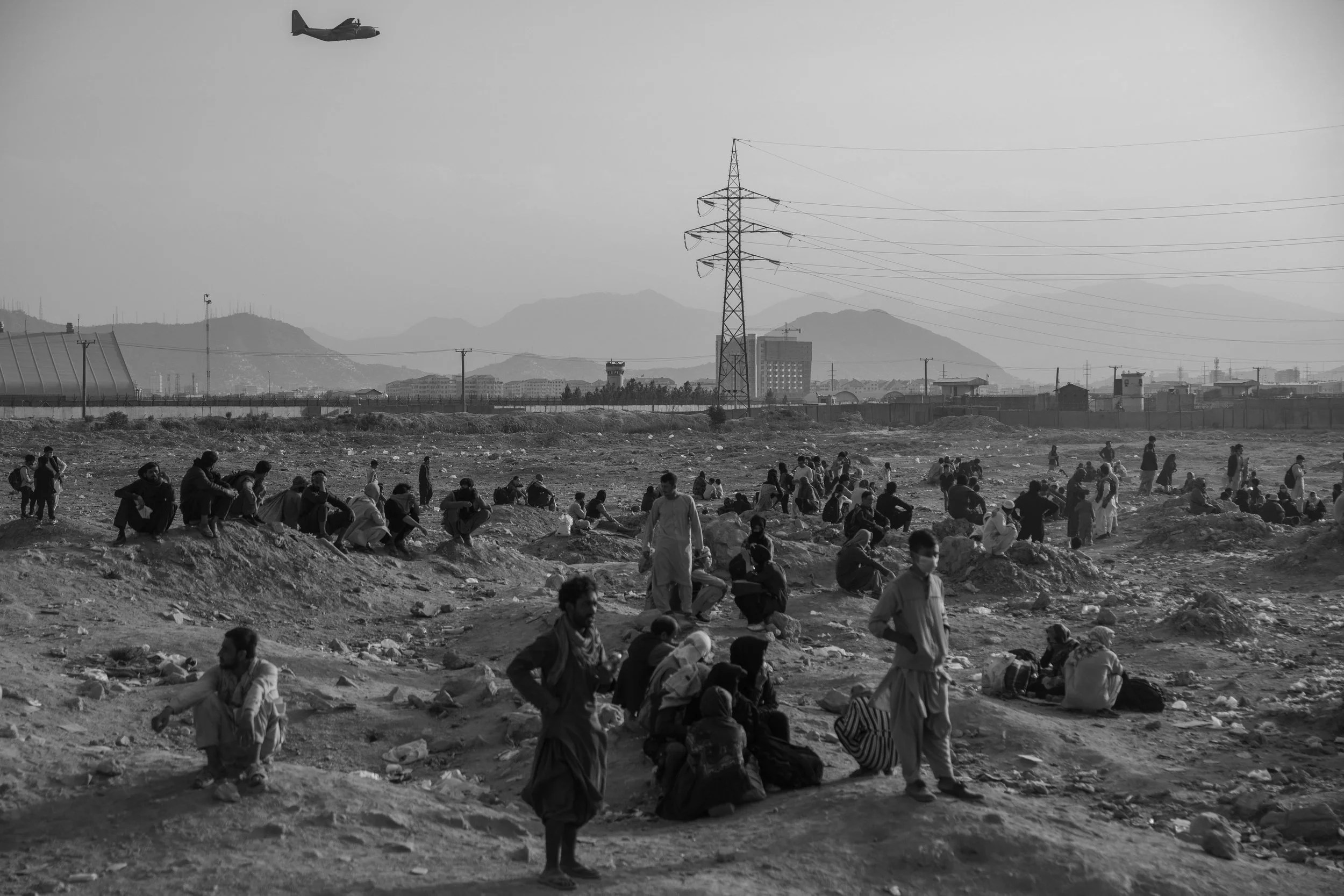  Desperate Afghans gather at the “Hollywood Gate” at Hamid Karzai International Airport in hopes of evacuation.  