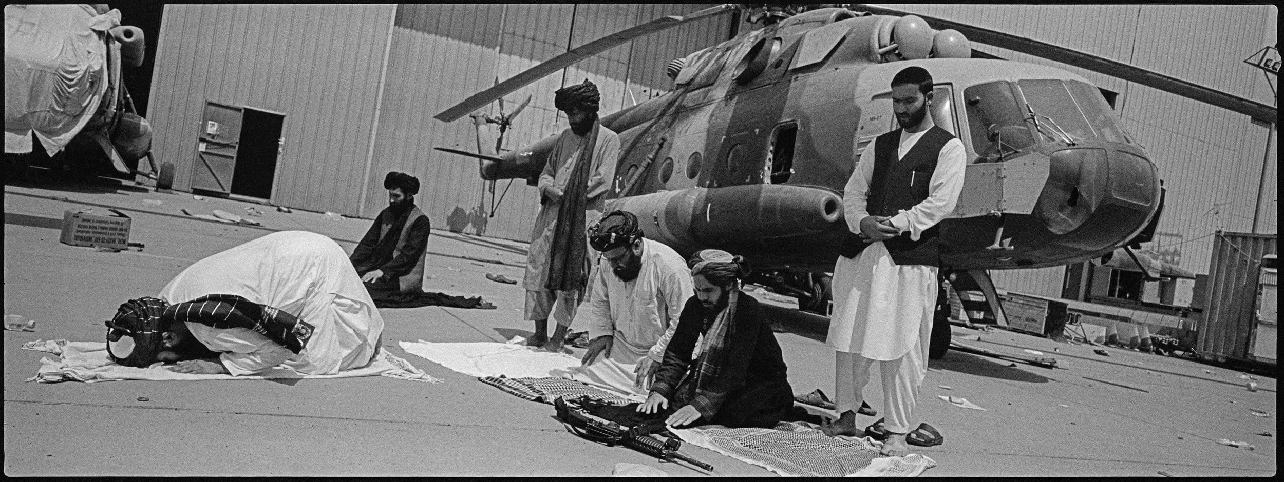  Taliban fighters celebrate their victory on the morning of the final US pullout.  
