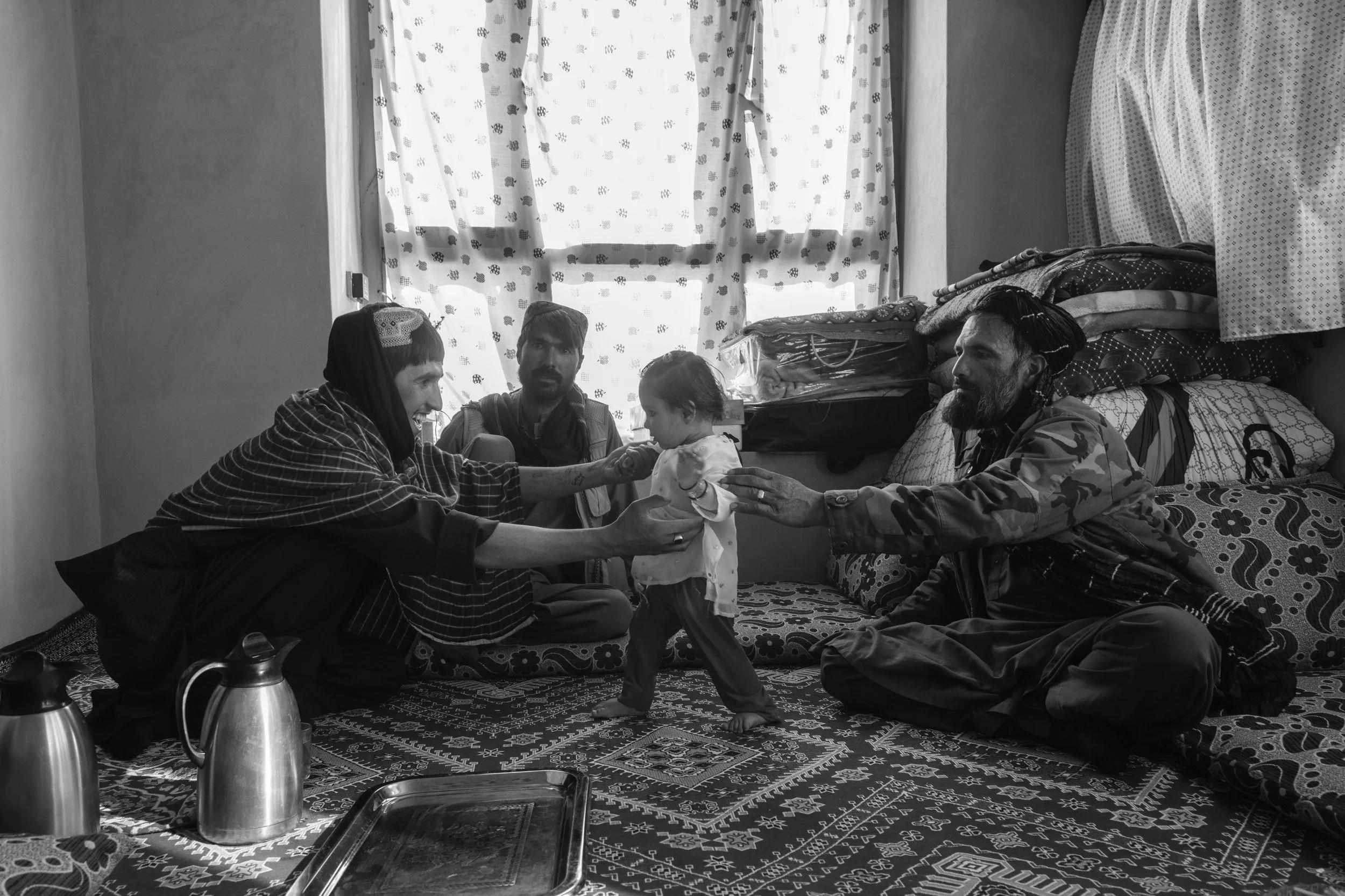  Taliban fighter Zahed holds his 18 month old sister, Chak district. 