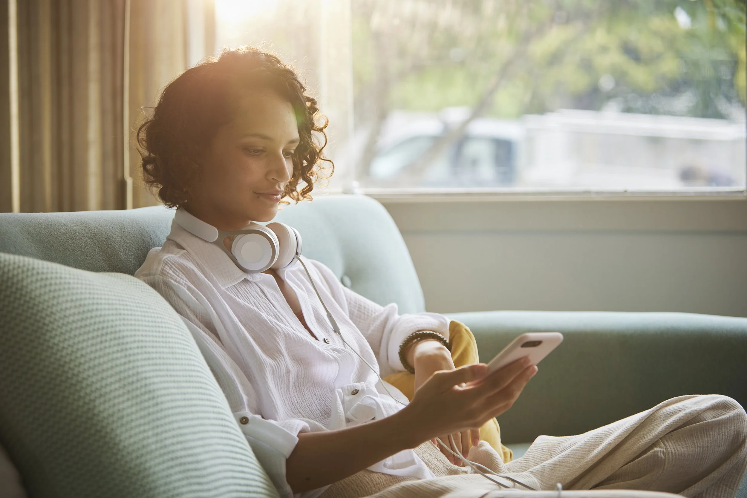 Snooze ‘a great day starts with a good night’s sleep’ campaign woman relaxing on sofa by Garth Oriander Photographer