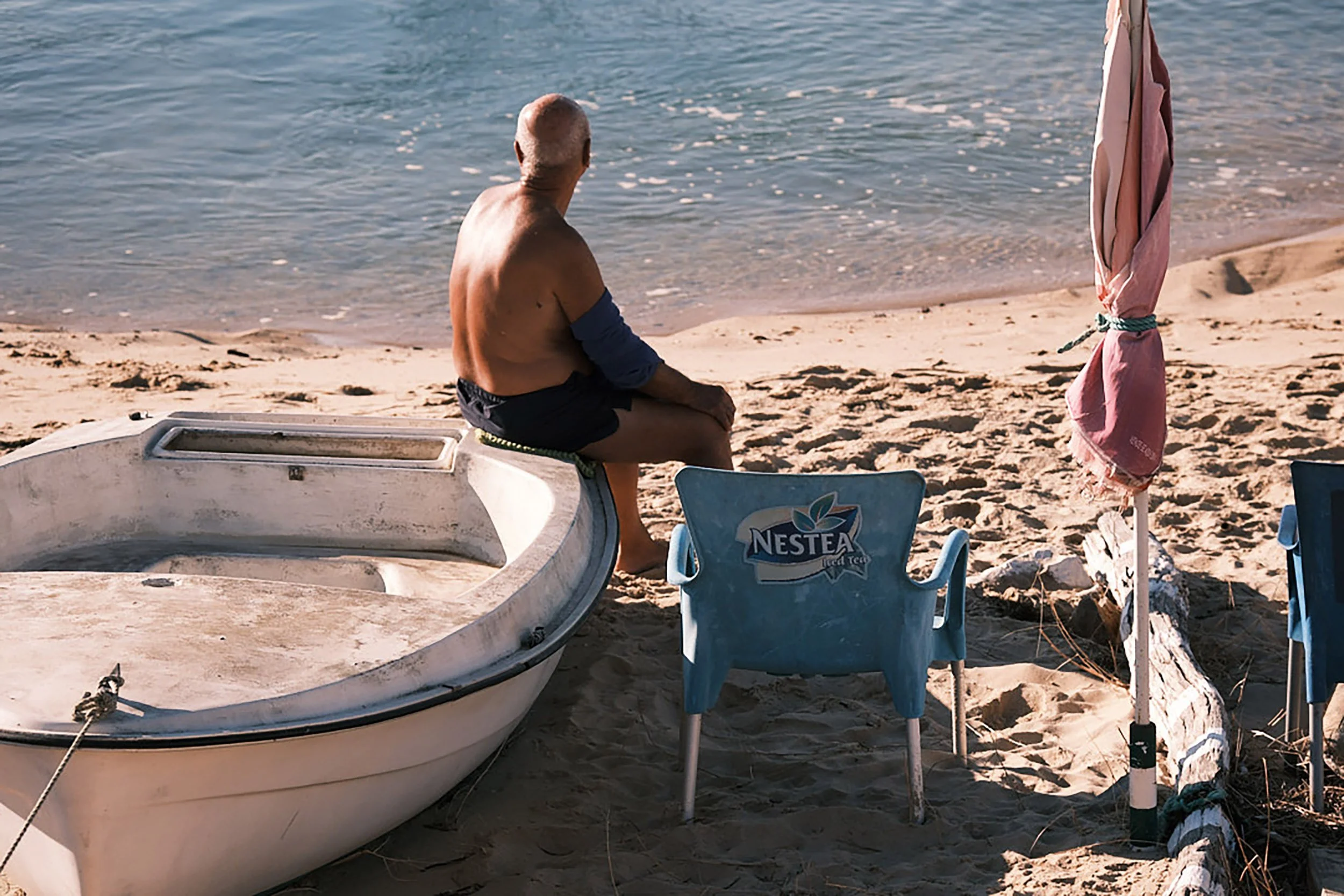 Man on Boat Tavira Portugal by Garth Oriander Photographer