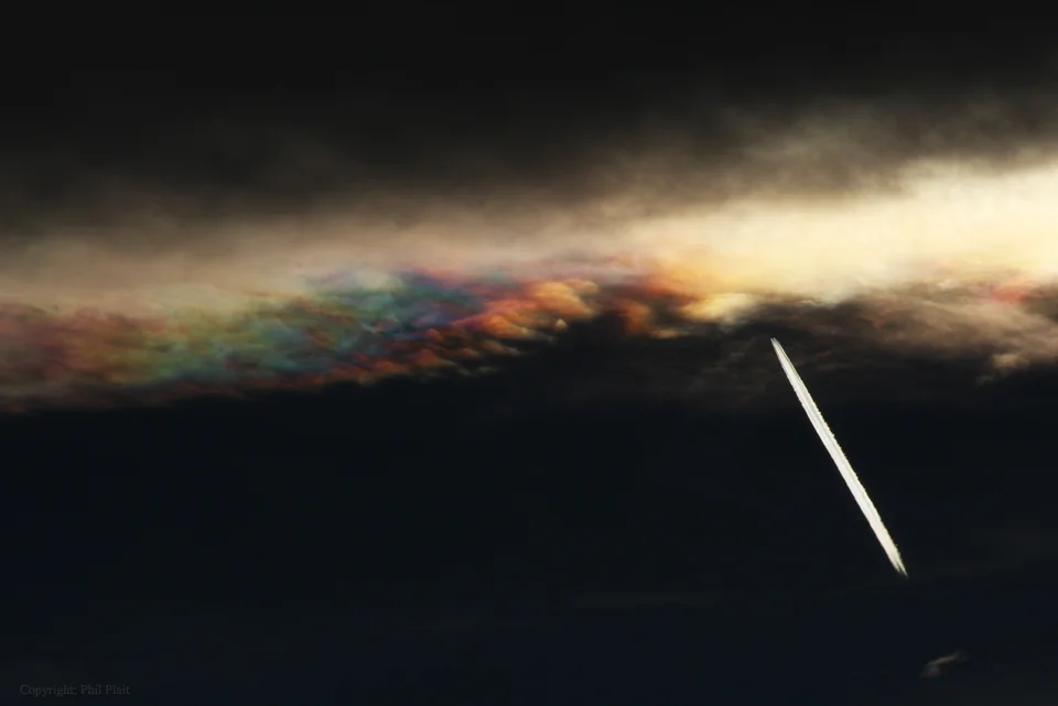 Sometimes your eclipse viewing goes bad in an interesting way. While watching and photographing last Thursday’s partial solar eclipse, a popular astronomy blogger suffered through long periods of clouds blocking the Sun. Unexpectedly, however, a nearby cloud began to show a rare effect: iridescence. Frequently part of a more familiar solarcorona effect, iridescence is the diffraction of sunlight around a thin screen of nearly uniformly-sized water droplets. Different colors of the sunlight become deflected by slightlydifferent angles and so come to the observer from slightly different directions. This display, featured here, was quite bright and exhibited an unusually broad range of colors. On the right, the contrails of an airplane are also visible.
from: APOD (NASA)