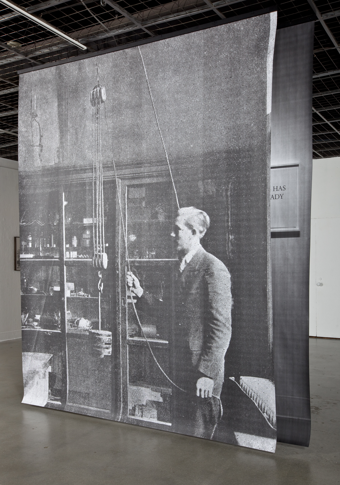  View of  Studying A Real Machine , 2010 (front) and  Everything Has Always Already Begun , 2010 (back) Both: Toner on paper, 8 x 10.5 feet 