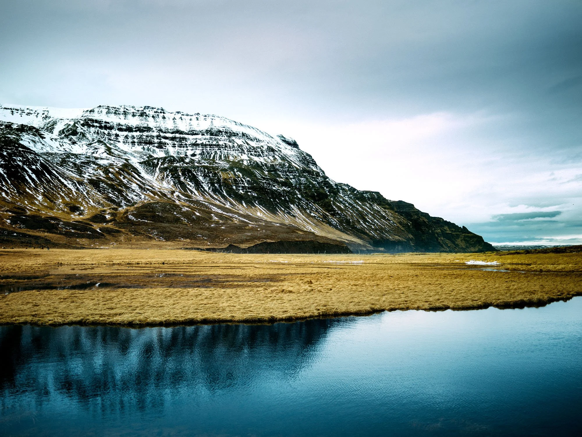 Snow-covered mountains reflected in a calm lake