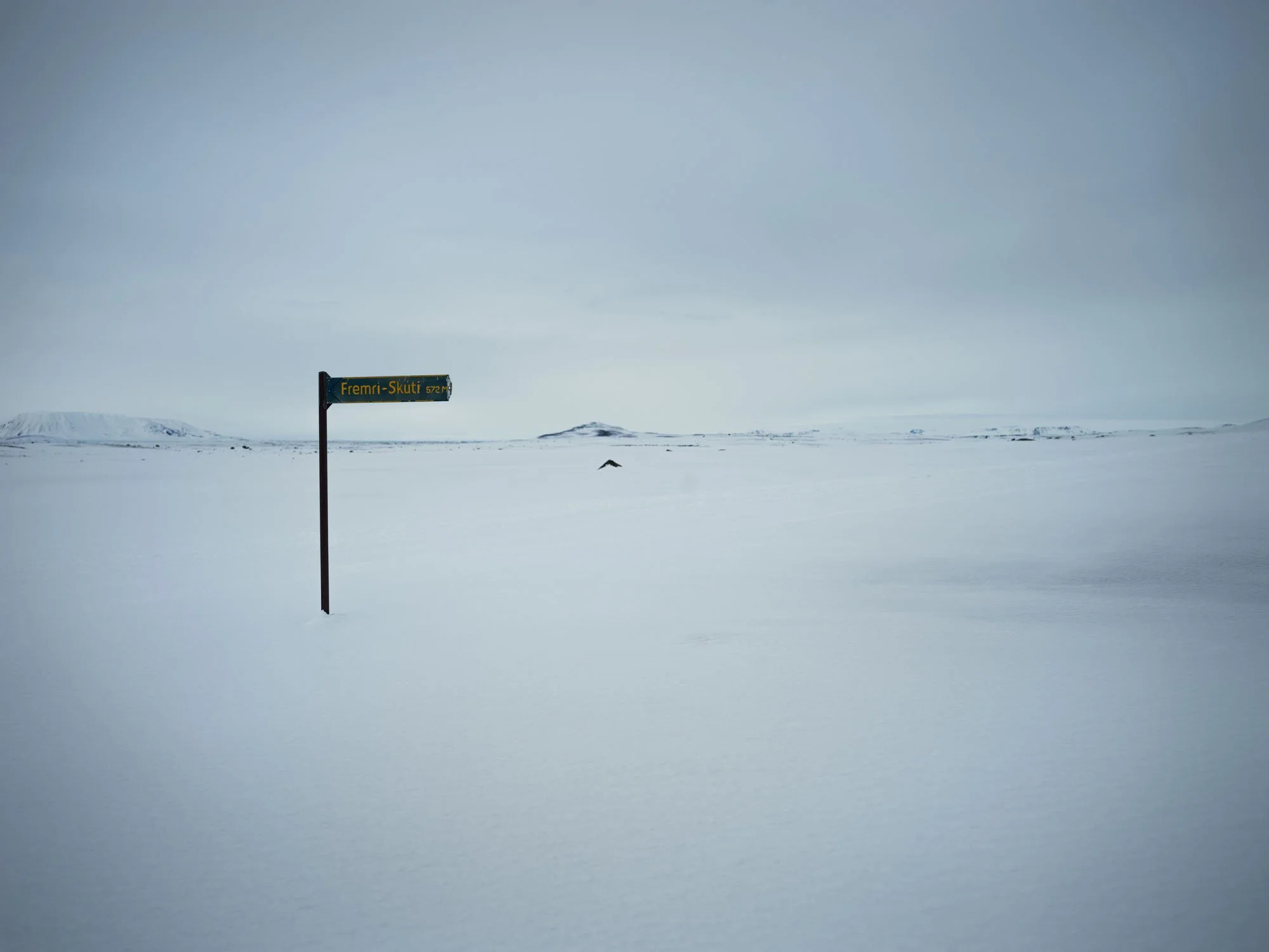 Road sign standing alone in a snow-covered landscape