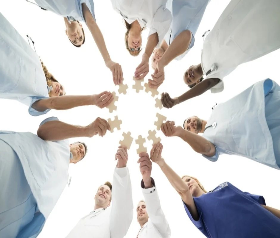 A medical team joining jigsaw pieces together — evidence-based practices combined into one system of care