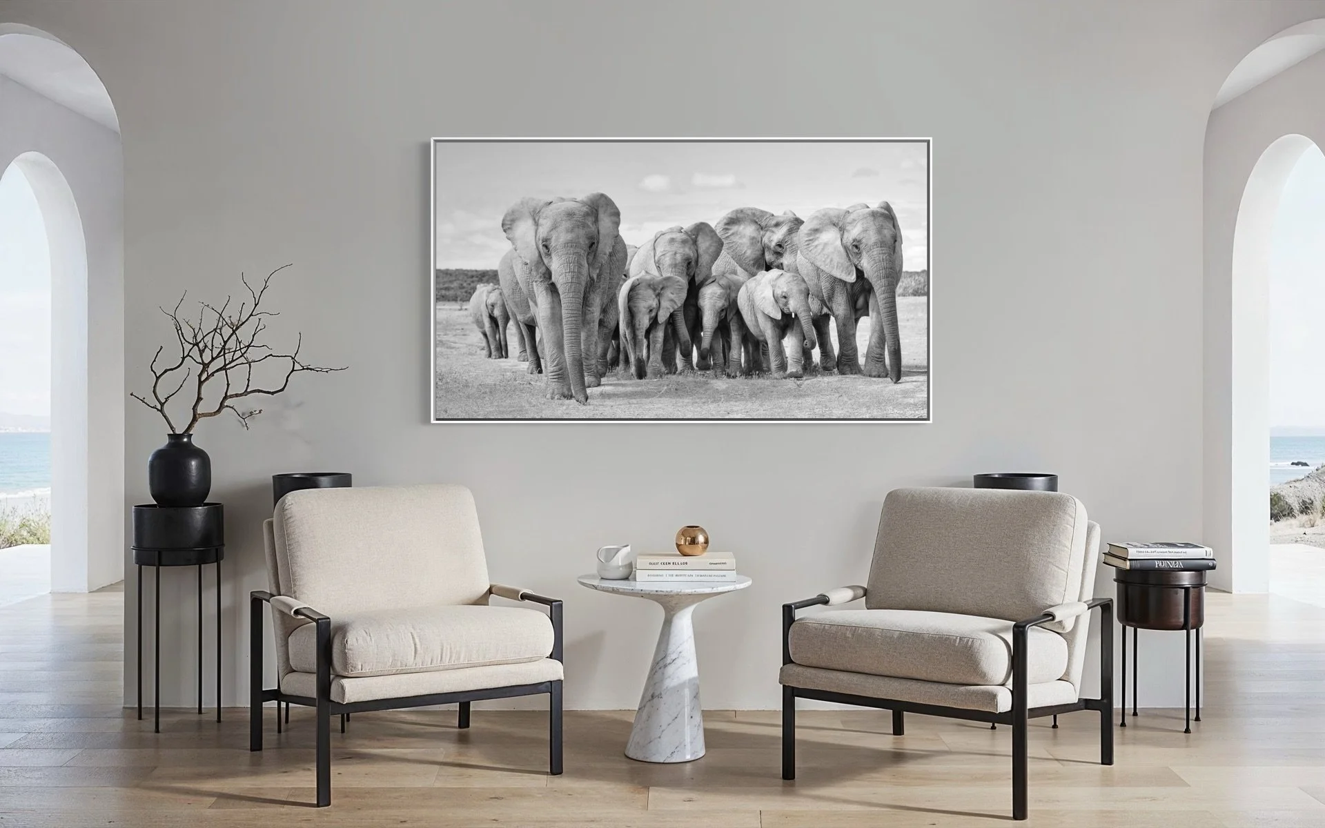 "Tuskless elephant mother and herd walking forward, acrylic wall art above two chairs in modern beach home interior."
