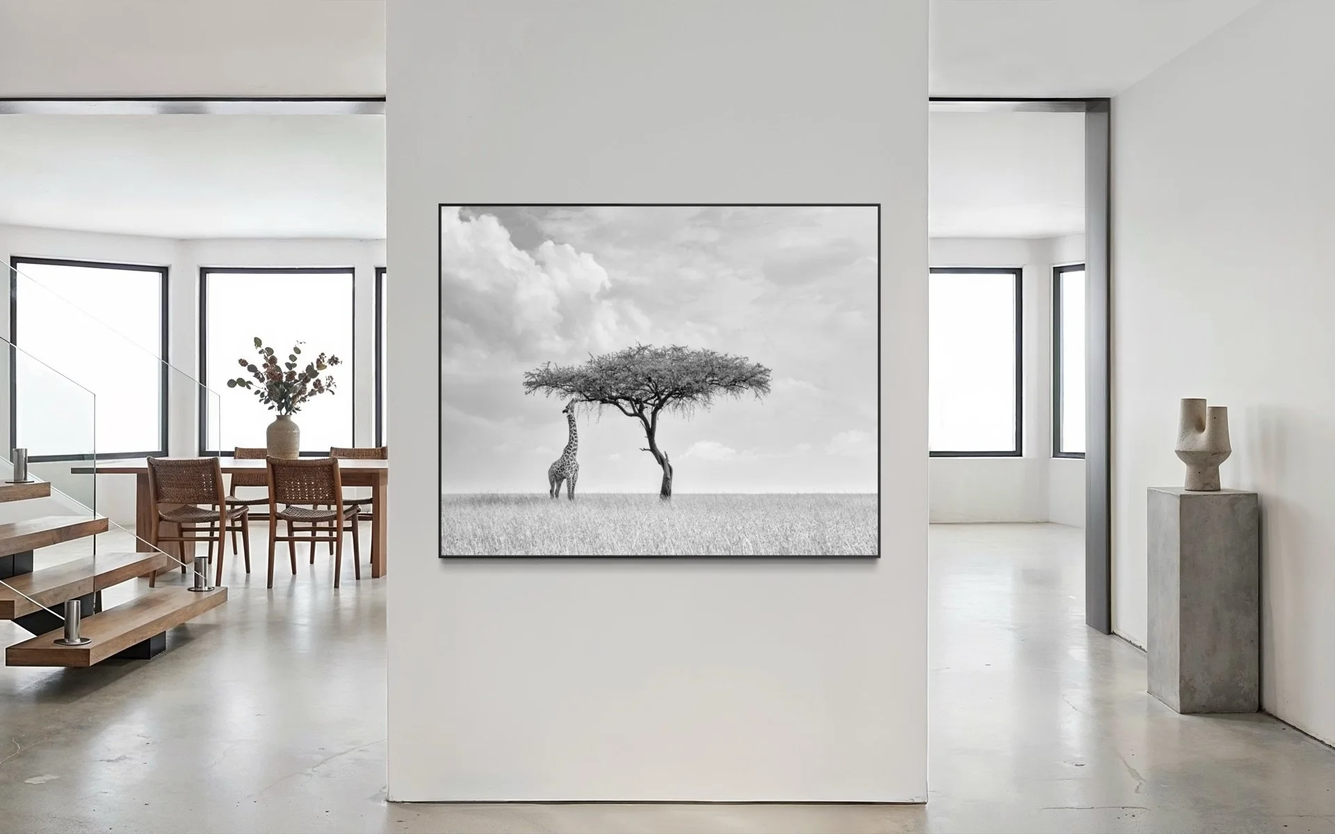 Beautiful framed print of a giraffe and acacia tree in a contemporary Mediterranean-style open-plan room