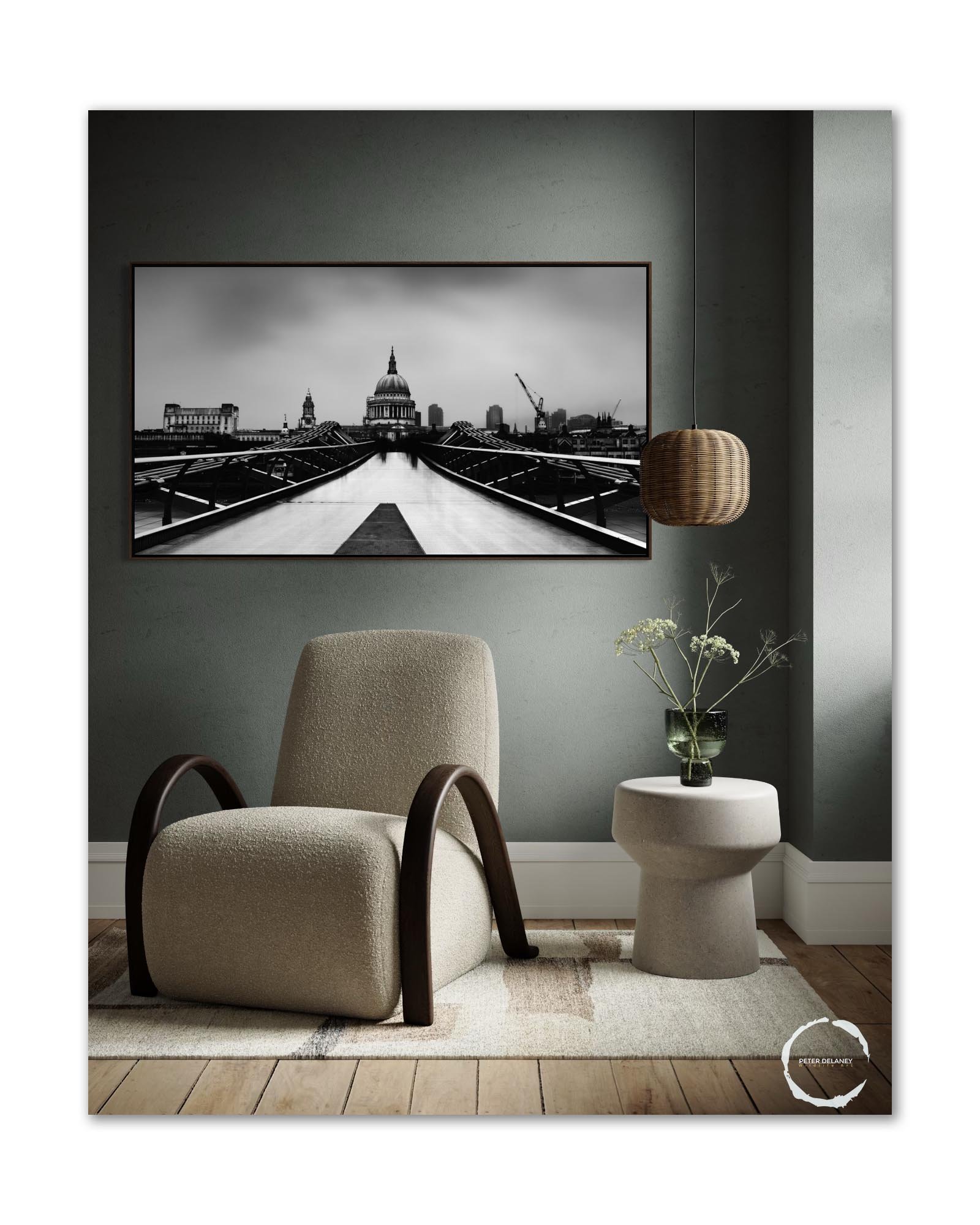 Framed black-and-white panoramic print of St Paul’s Cathedral hanging above a chair in a modern living room, showcasing the artwork’s scale and elegance within a curated interior.