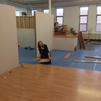Laying down the laminate floorboards in the new space