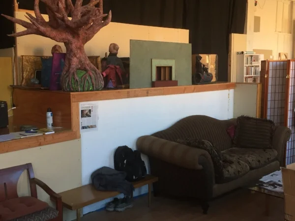 Common area with couch in front of the covered-up conveyor belt