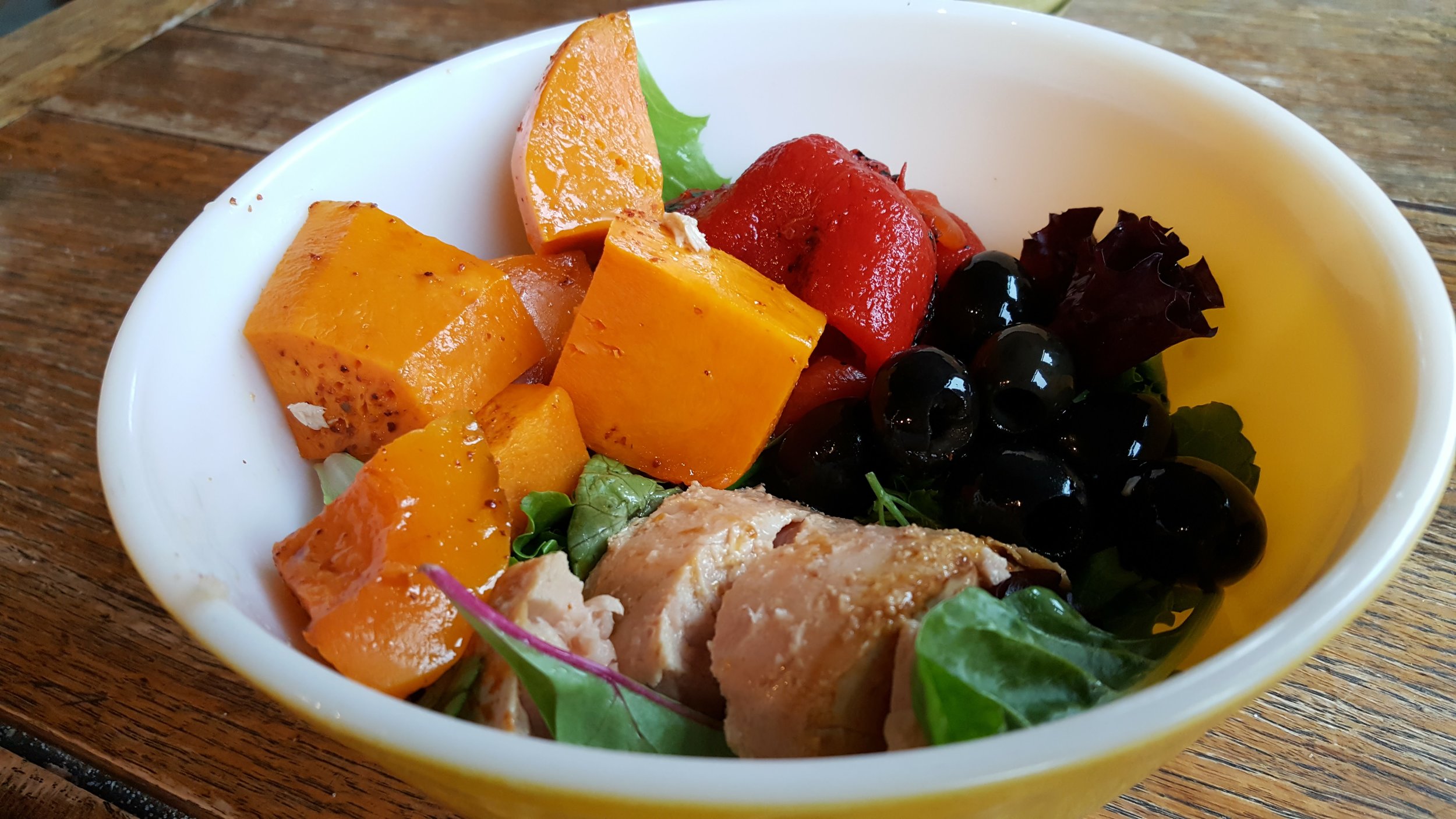 Breakfast bowl of butternut squash, tuna, olives and red peppers