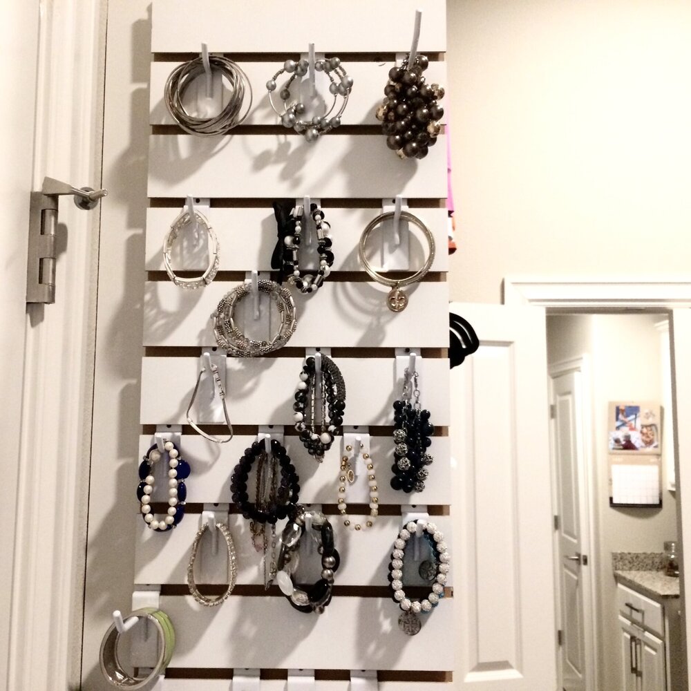 A custom slat wall is a convenient, low-profile solution for jewelry storage. Call Closets of Tulsa today for a  FREE virtual consultation and 3-D closet design :  918.609.0214