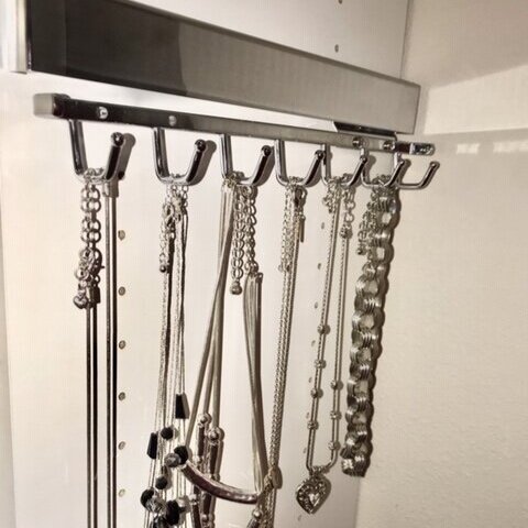 A slide out belt rack doubles as a beautiful necklace organizer. Call Closets of Tulsa today for a  FREE virtual consultation and 3-D closet design :  918.609.0214