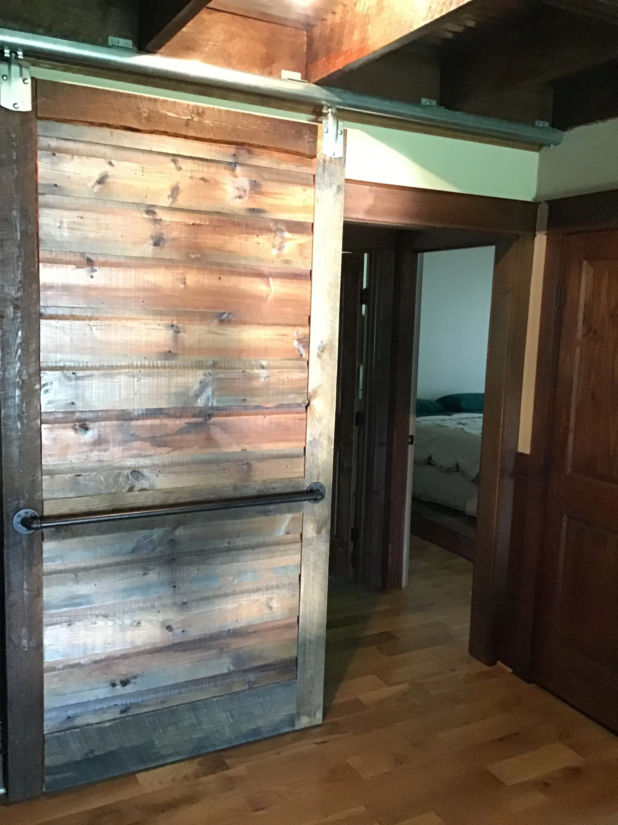 “custom made barn door from old house siding”