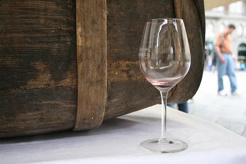 empty wine glass in front of barrel