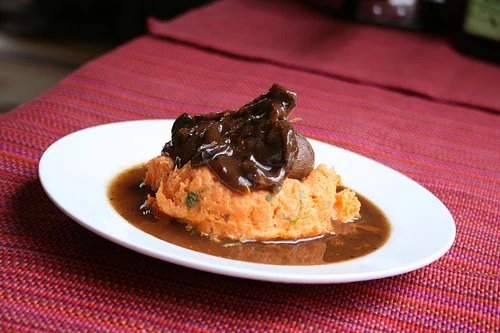 braised beef with red wine, onion brulee served on chive sweet potatoes