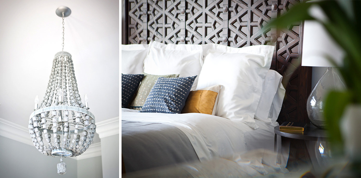 white chandelier, bed, wood headboard, throw pillows