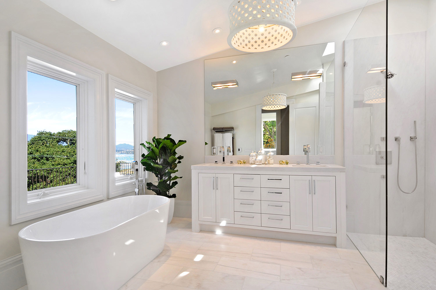 indoor plants, fiddle leaf fig, bathroom, modern bath, tub, vanity, his and hers sinks, bathroom cabinetry, cabinet pulls, shower, tile flooring, marble shower walls