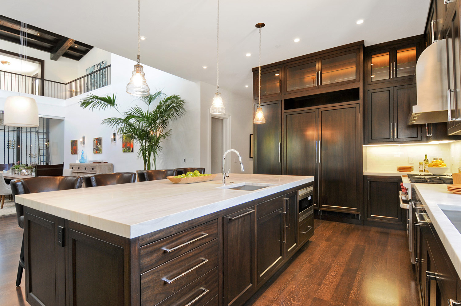 ktichen, cabinetry, hardwood floors, wolf stove, marble counters, barstools, kitchen pendant, stainless steel range, high ceilings