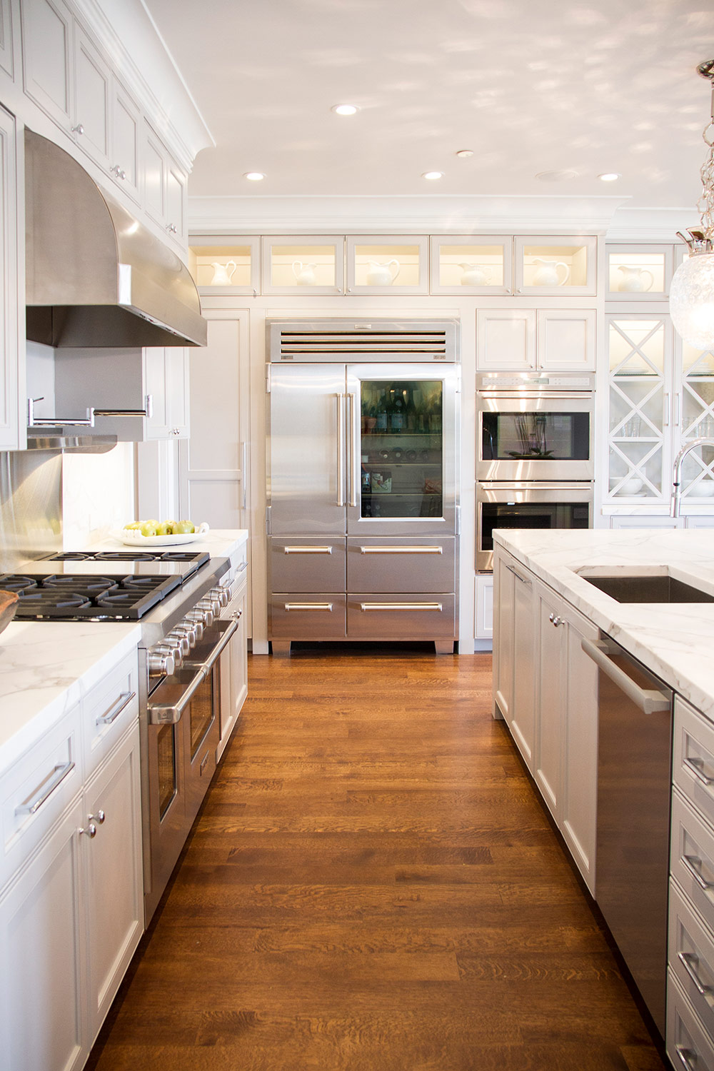 kitchen, white, simple, stainless steel, fridge, marble counters, overhead lighting, modern 